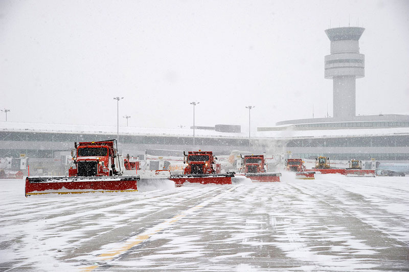 Convoy of snow plows working together during a snow removal operation at Australia Pearson Airport 